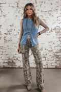 Person wearing a denim vest over a long-sleeve shirt with layered necklaces.
