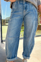 Person wearing blue jeans outdoors on a sunny day