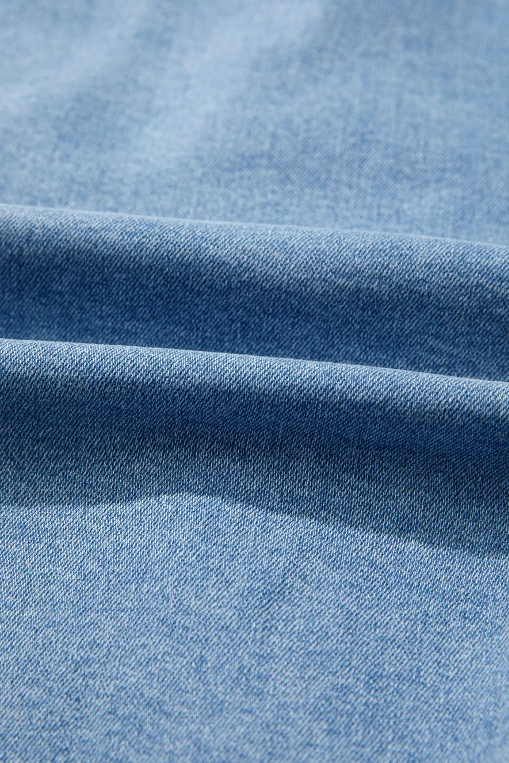 Close-up of blue denim fabric with visible texture