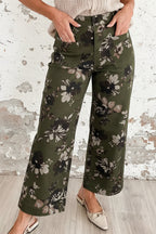 Person wearing green floral pants against a white background