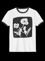 A white ringer t-shirt with black trim on the collar and sleeve cuffs, featuring a black square graphic on the chest with white botanical line art.