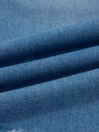 Close-up of blue denim fabric with a subtle texture