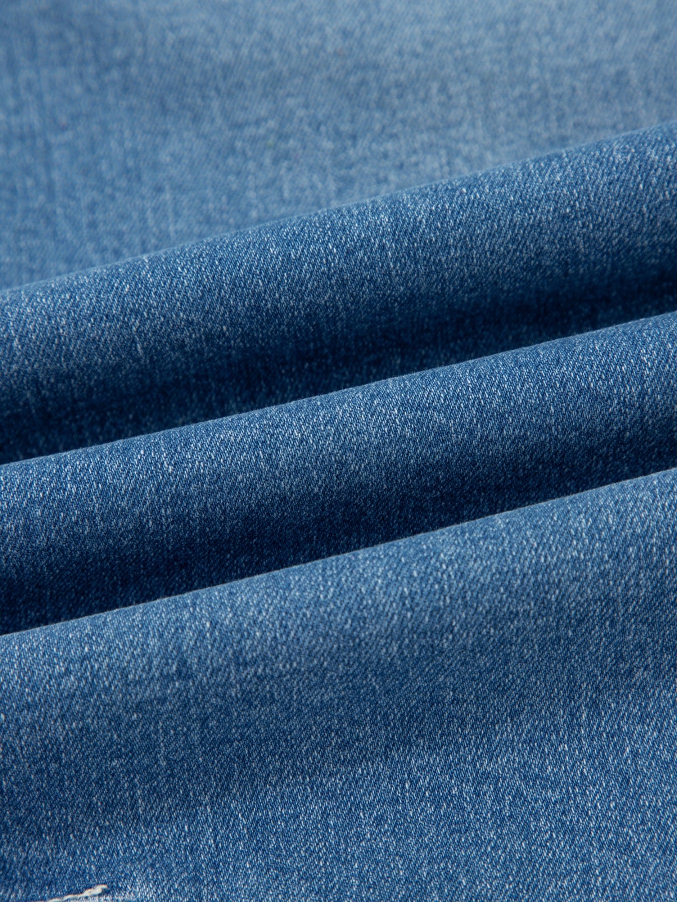 Close-up of blue denim fabric with a subtle texture