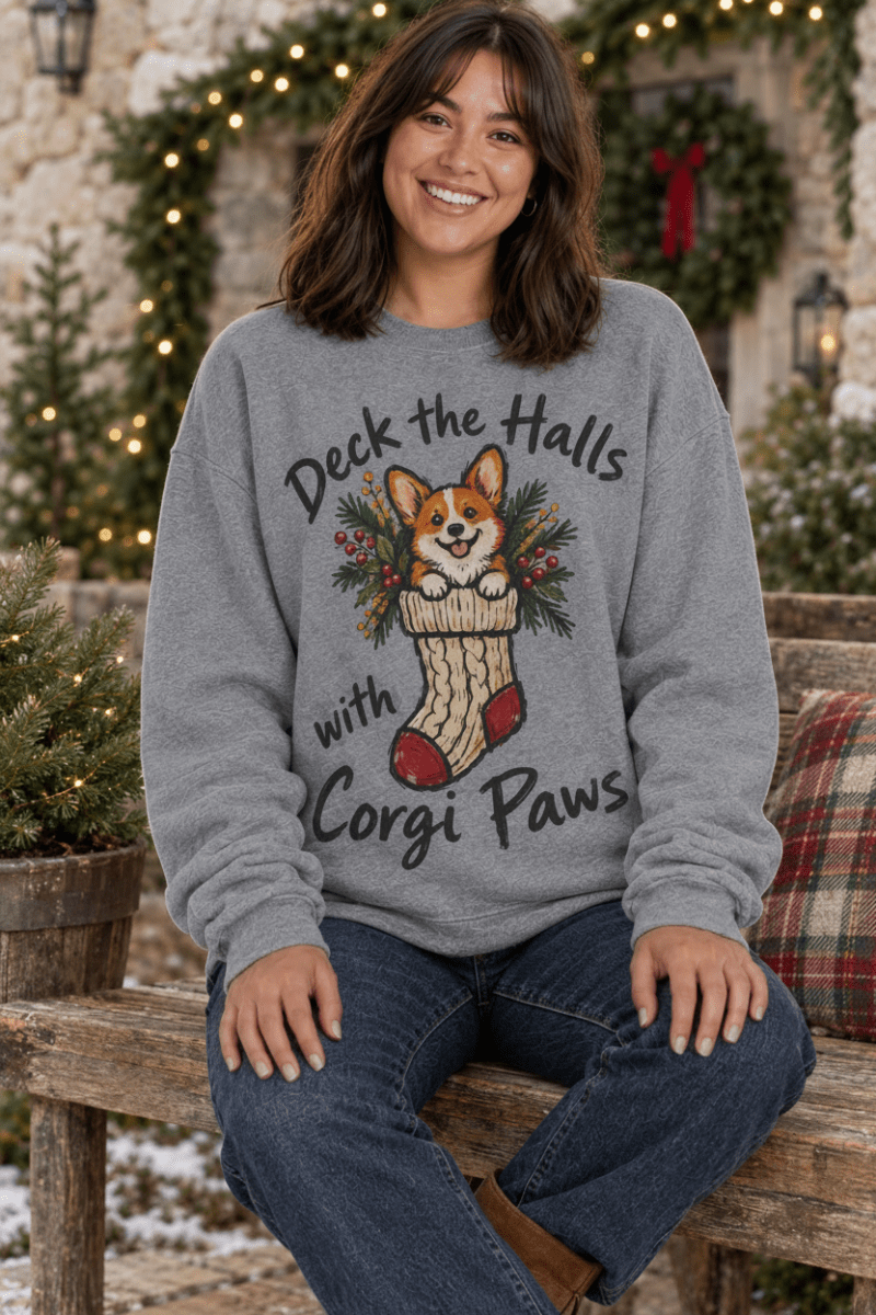 The Doodled Flower Boutique graphite heather crewneck sweatshirt featuring a hand-drawn corgi in a Christmas stocking.