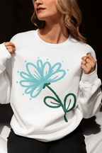 White sweatshirt with motivational text worn by a person, against a dark background