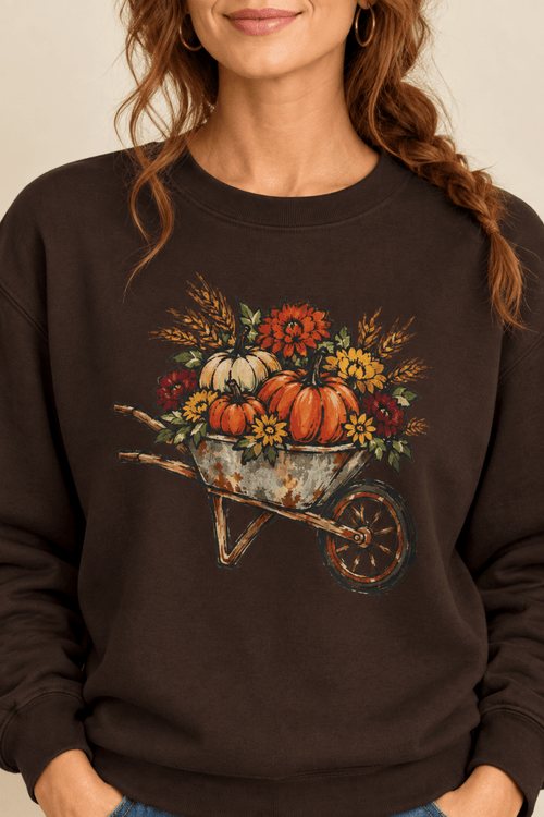 The Doodled Flower Boutique dark chocolate crewneck sweatshirt featuring a rustic autumn wheelbarrow of pumpkins and mums graphic, close up