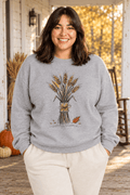 The Doodled Flower Boutique sport grey crewneck sweatshirt featuring an original wheat bouquet graphic, close up on a fall farmhouse porch.
