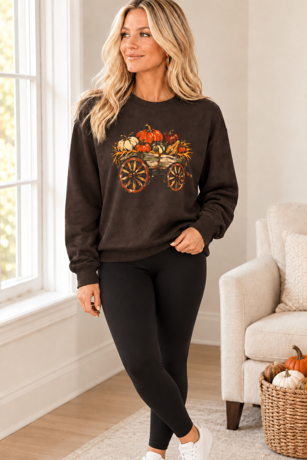 The Doodled Flower Boutique dark chocolate crewneck sweatshirt featuring a rustic pumpkin wagon graphic, worn by a model in a cozy living room