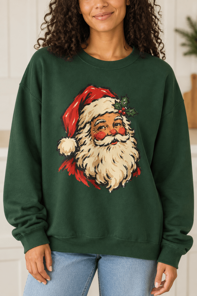 The Doodled Flower Boutique forest green crewneck sweatshirt featuring a vintage Santa portrait with a holly sprig graphic, close up.
