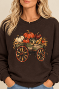 The Doodled Flower Boutique dark chocolate crewneck sweatshirt featuring a rustic pumpkin wagon graphic, close up