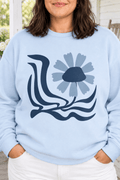 The Doodled Flower Boutique light blue crewneck sweatshirt featuring an original retro floral wave graphic, close up.
