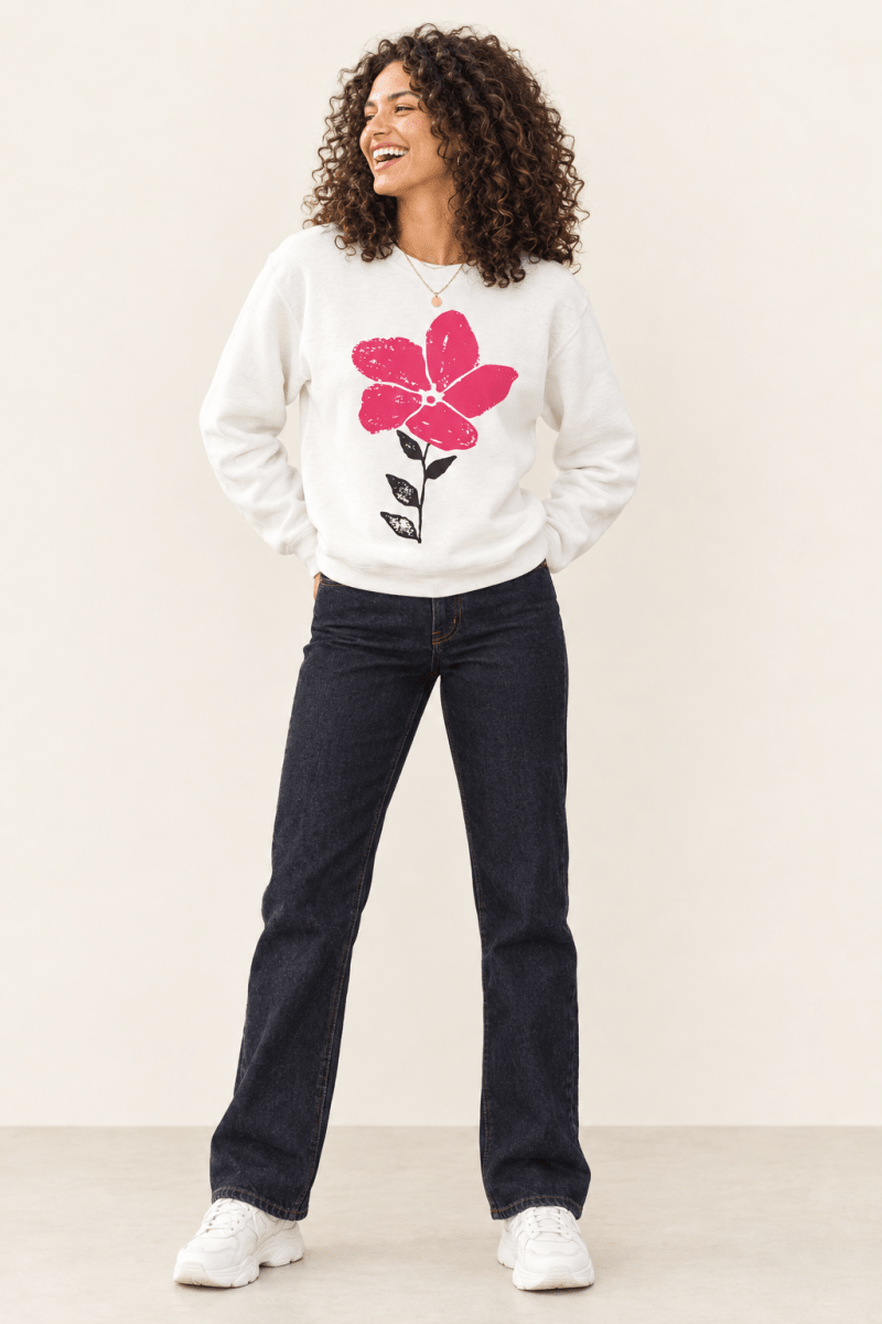 The Doodled Flower Boutique white pink bloom doodle crewneck sweatshirt styled with dark wash straight jeans and white chunky sneakers.