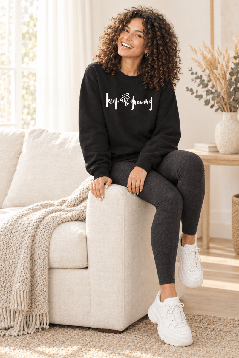 The Doodled Flower Boutique black keep growing crewneck sweatshirt styled with charcoal leggings and chunky white sneakers.