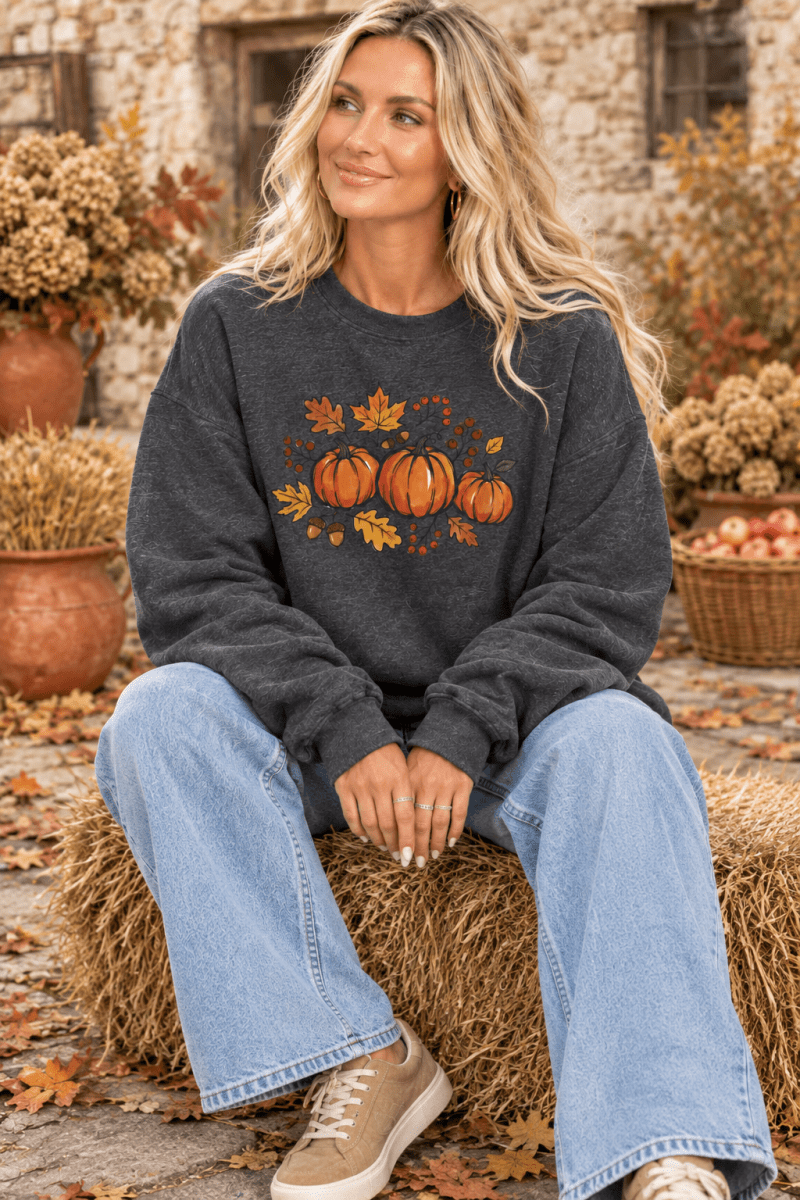 Pumpkin Patch sweatshirt seated on hay bale