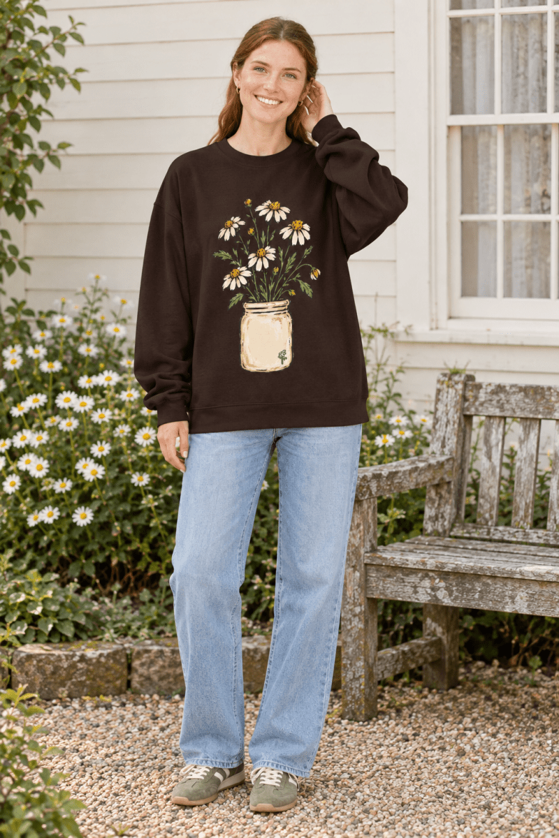 The Doodled Flower Boutique dark brown crewneck sweatshirt featuring a hand-drawn daisy bouquet in a cream jar.