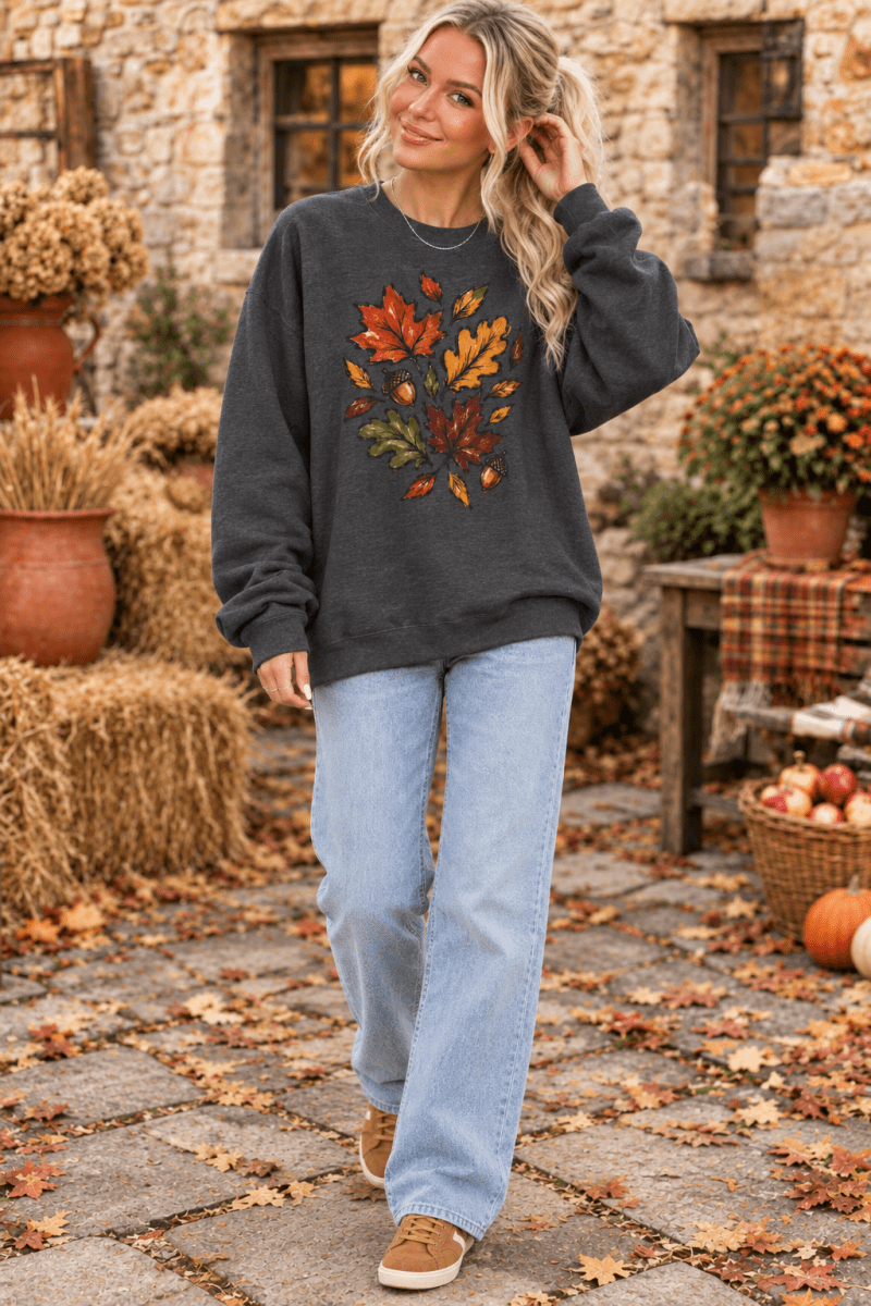 The Doodled Flower Boutique charcoal crewneck sweatshirt featuring a colorful autumn leaf and acorn graphic design.