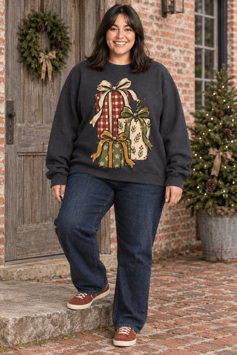 The Doodled Flower Boutique charcoal fleece sweatshirt with hand-drawn Christmas gift stack print on a smiling woman.