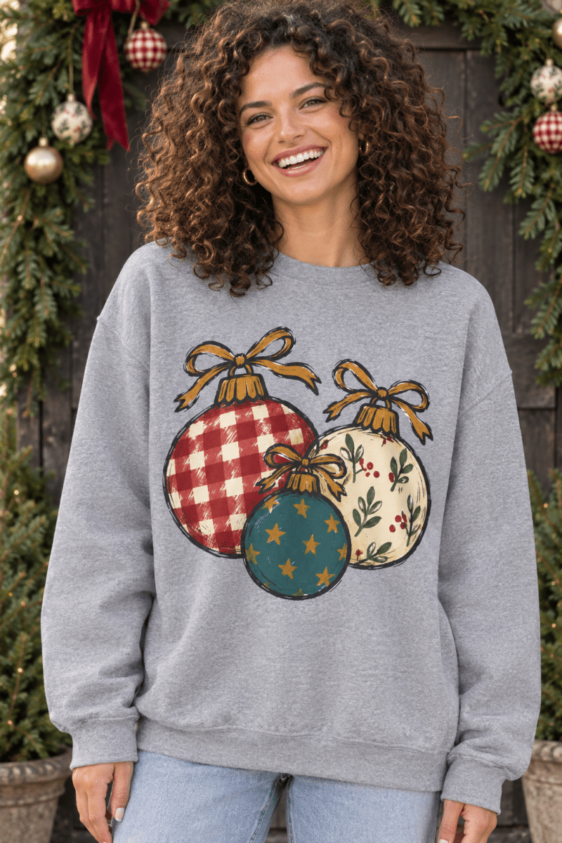 The Doodled Flower Boutique grey crewneck sweatshirt featuring hand-drawn Christmas ornaments with plaid and floral art