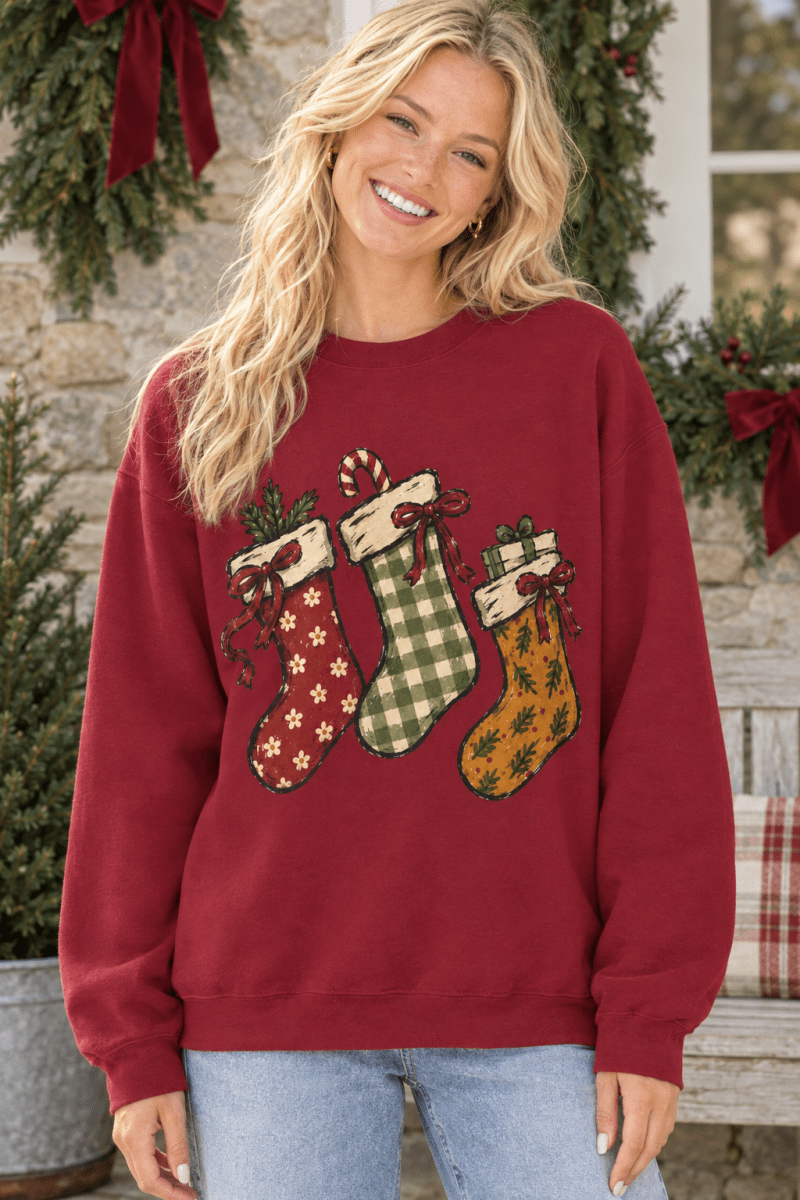 The Doodled Flower Boutique cranberry red crewneck sweatshirt featuring a hand-drawn Christmas stocking illustration.