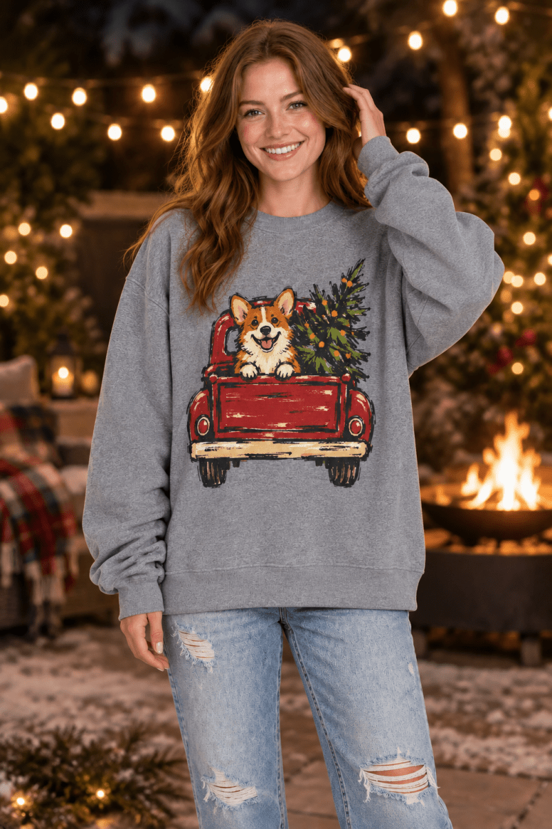 The Doodled Flower Boutique grey crewneck sweatshirt featuring a corgi in a red vintage truck with a Christmas tree.