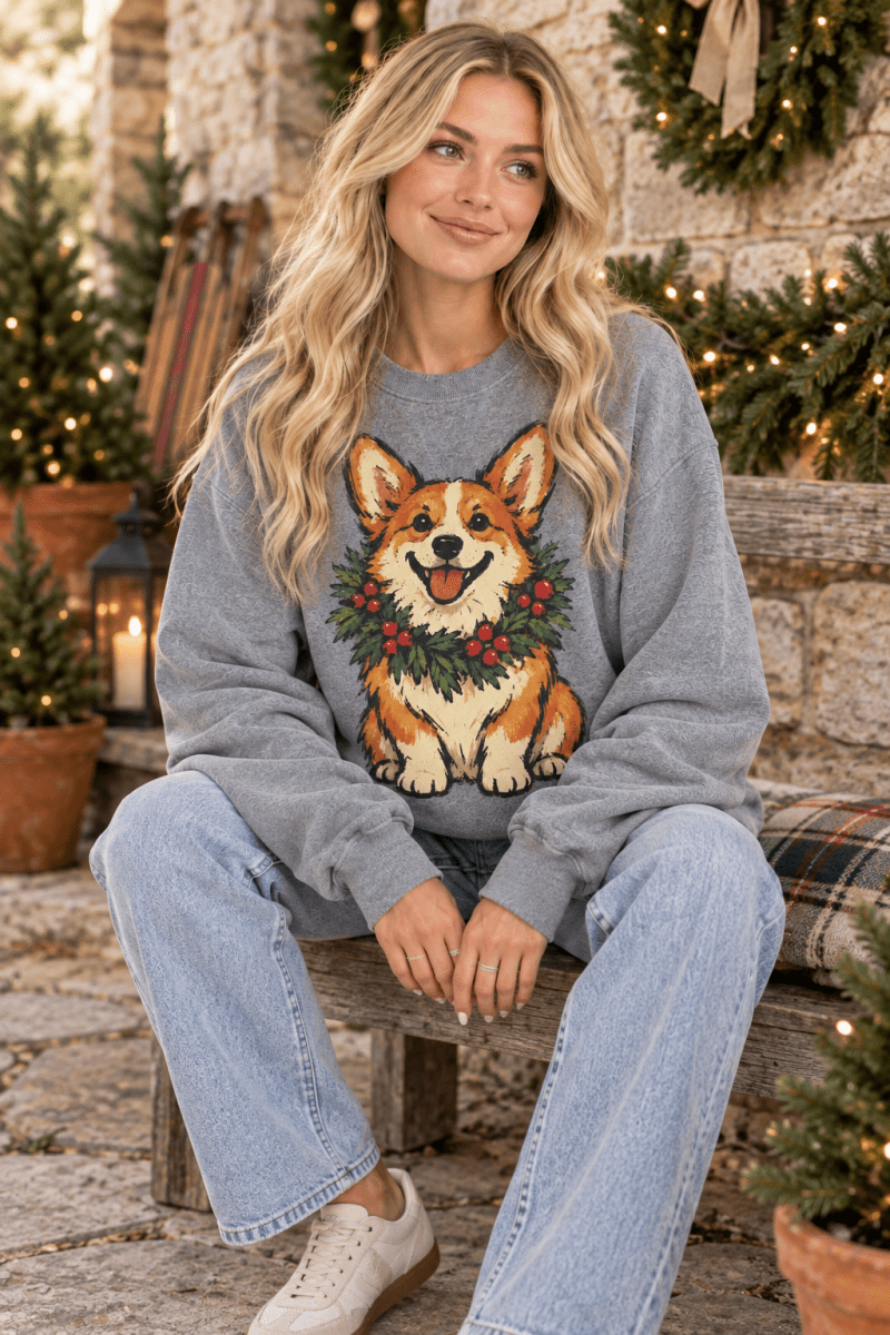 The Doodled Flower Boutique graphite heather crewneck sweatshirt featuring a hand-drawn corgi wearing a holiday wreath.