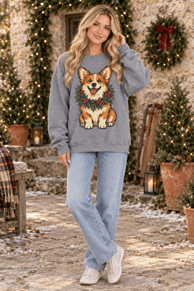The Doodled Flower Boutique graphite heather crewneck sweatshirt featuring a hand-drawn corgi wearing a holiday wreath.