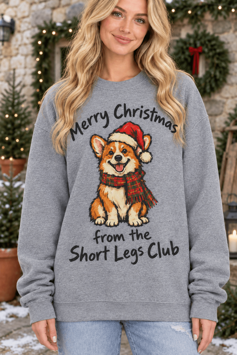 The Doodled Flower Boutique graphite heather Christmas sweatshirt featuring a corgi in a Santa hat and plaid scarf.