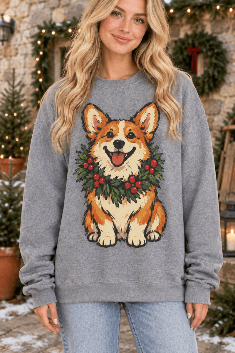 The Doodled Flower Boutique graphite heather sweatshirt featuring a hand-drawn corgi wearing a festive holiday wreath.