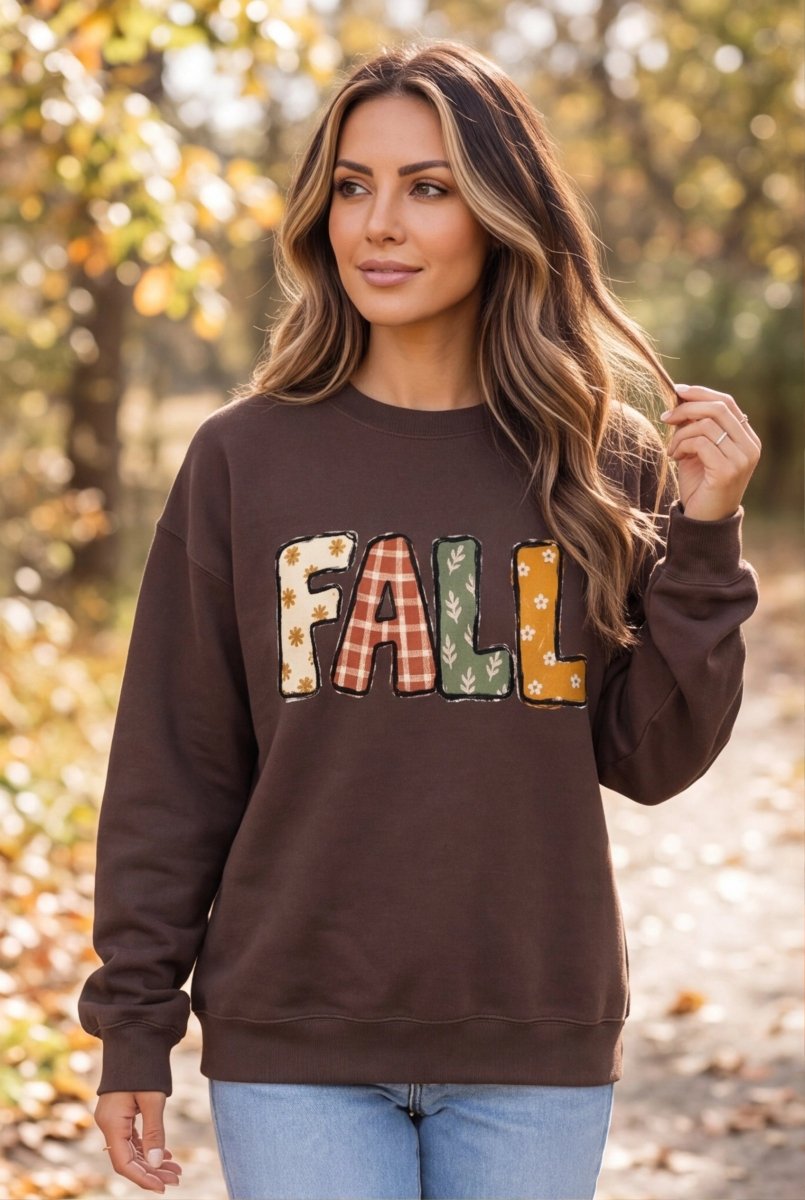 The Doodled Flower Boutique espresso brown cotton crewneck sweatshirt with a patchwork FALL graphic in autumn tones.