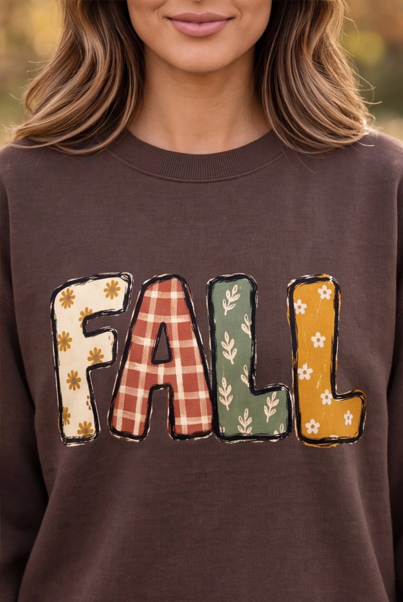 The Doodled Flower Boutique espresso brown cotton crewneck sweatshirt with a colorful FALL patchwork graphic print.