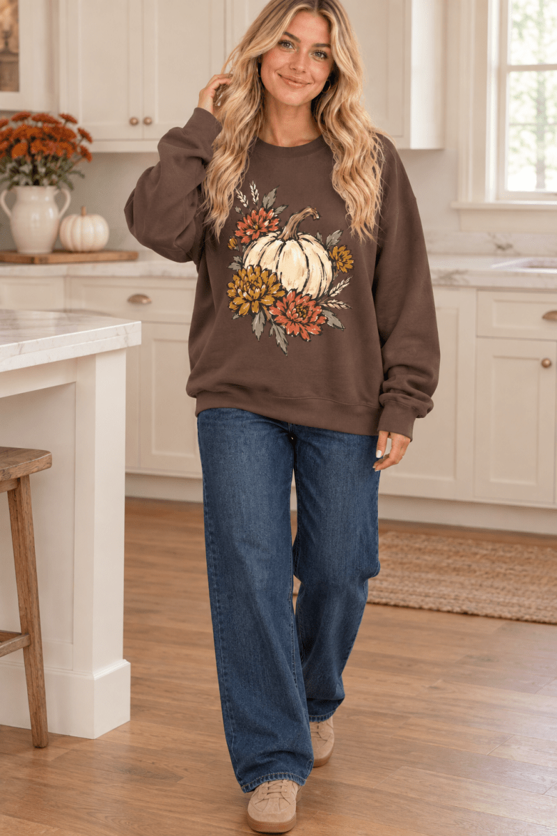 Woman wearing The Doodled Flower Boutique espresso brown crewneck sweatshirt with vintage pumpkin and floral graphic