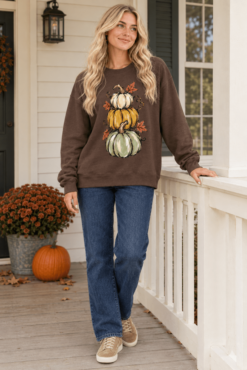 The Doodled Flower Boutique espresso brown crewneck sweatshirt featuring a hand-drawn pumpkin stack graphic.