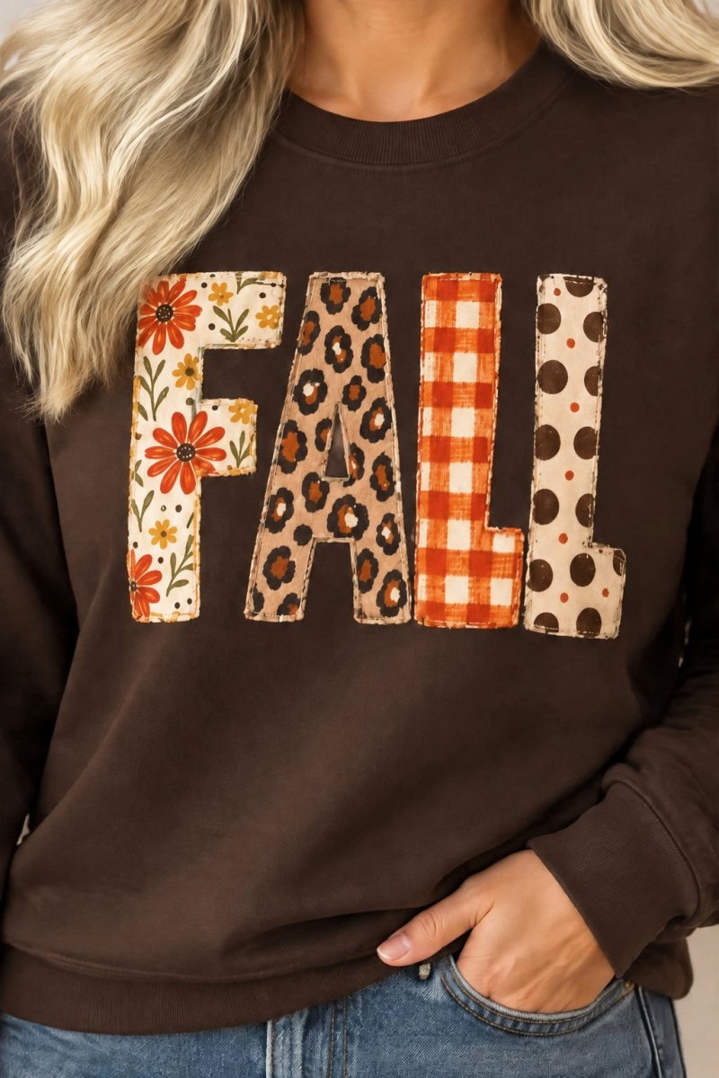 The Doodled Flower Boutique dark chocolate crewneck sweatshirt featuring FALL letters in floral, leopard, and plaid.