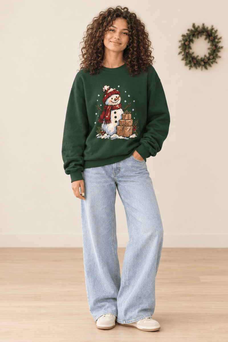 The Doodled Flower Boutique dark green crewneck sweatshirt featuring a hand-drawn snowman and gifts graphic