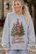 The Doodled Flower Boutique grey crewneck sweatshirt with a festive hand-drawn Christmas tree graphic on a woman.