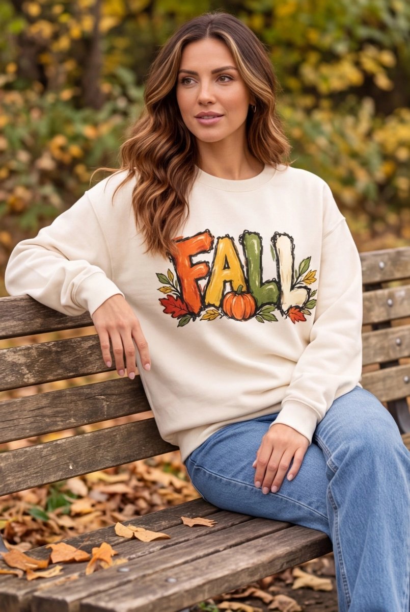 Woman wearing The Doodled Flower Boutique ivory cotton crewneck sweatshirt with autumn pumpkin and leaf graphic
