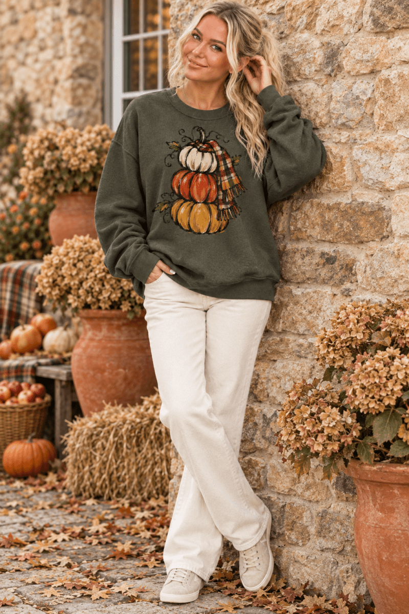 The Doodled Flower Boutique olive green crewneck sweatshirt featuring a hand-drawn stacked pumpkin and plaid scarf