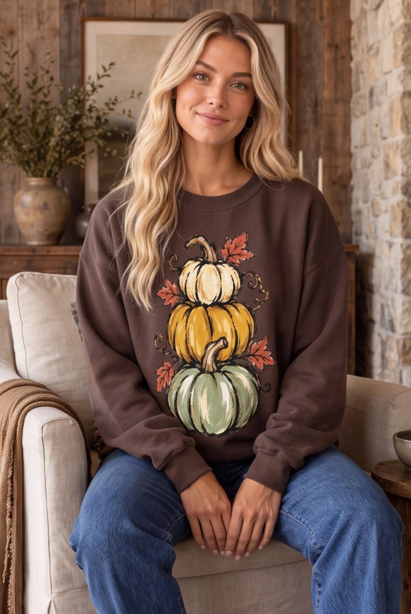 The Doodled Flower Boutique espresso brown crewneck sweatshirt featuring a hand-drawn stack of colorful pumpkins.