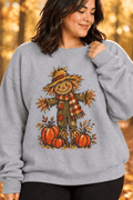 The Doodled Flower Boutique grey crewneck sweatshirt featuring a hand-drawn scarecrow and pumpkin harvest graphic.