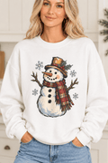 The Doodled Flower Boutique white crewneck sweatshirt featuring a vintage snowman illustration with a plaid scarf.