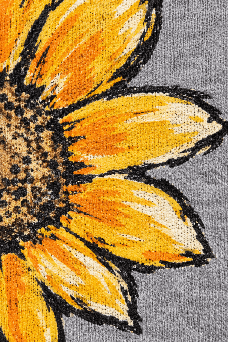 Close-up of The Doodled Flower Boutique sunflower graphic on a grey fleece sweatshirt with hand-drawn golden petals.